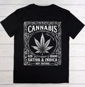 A black short-sleeve crewneck t-shirt laid flat on a white wood plank background. The front features a large white graphic print styled like a vintage ornate label, containing a cannabis leaf, the word 'CANNABIS', 'High Quality', '420 BRAND', 'SATIVA & INDICA', and '100% NATURAL'.