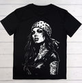 A black short-sleeve crewneck t-shirt featuring a large white graphic print of a woman with a bandana decorated with stars, laid flat on a white wood plank background.