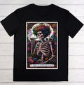 A black short-sleeve crewneck t-shirt featuring a large graphic print of 'The Gardener' tarot card on the front, displayed flat against a light gray wood plank background.