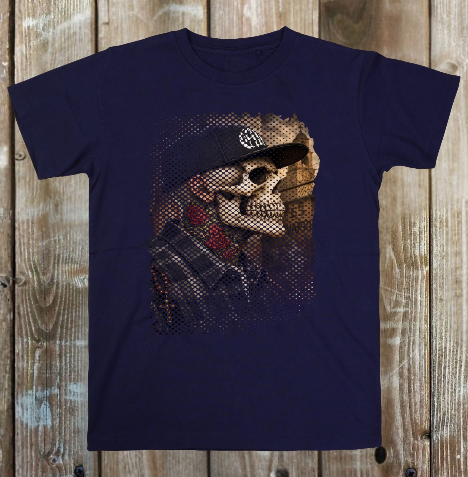Navy blue t-shirt with a graphic design of a skeleton wearing a cap on a wooden surface