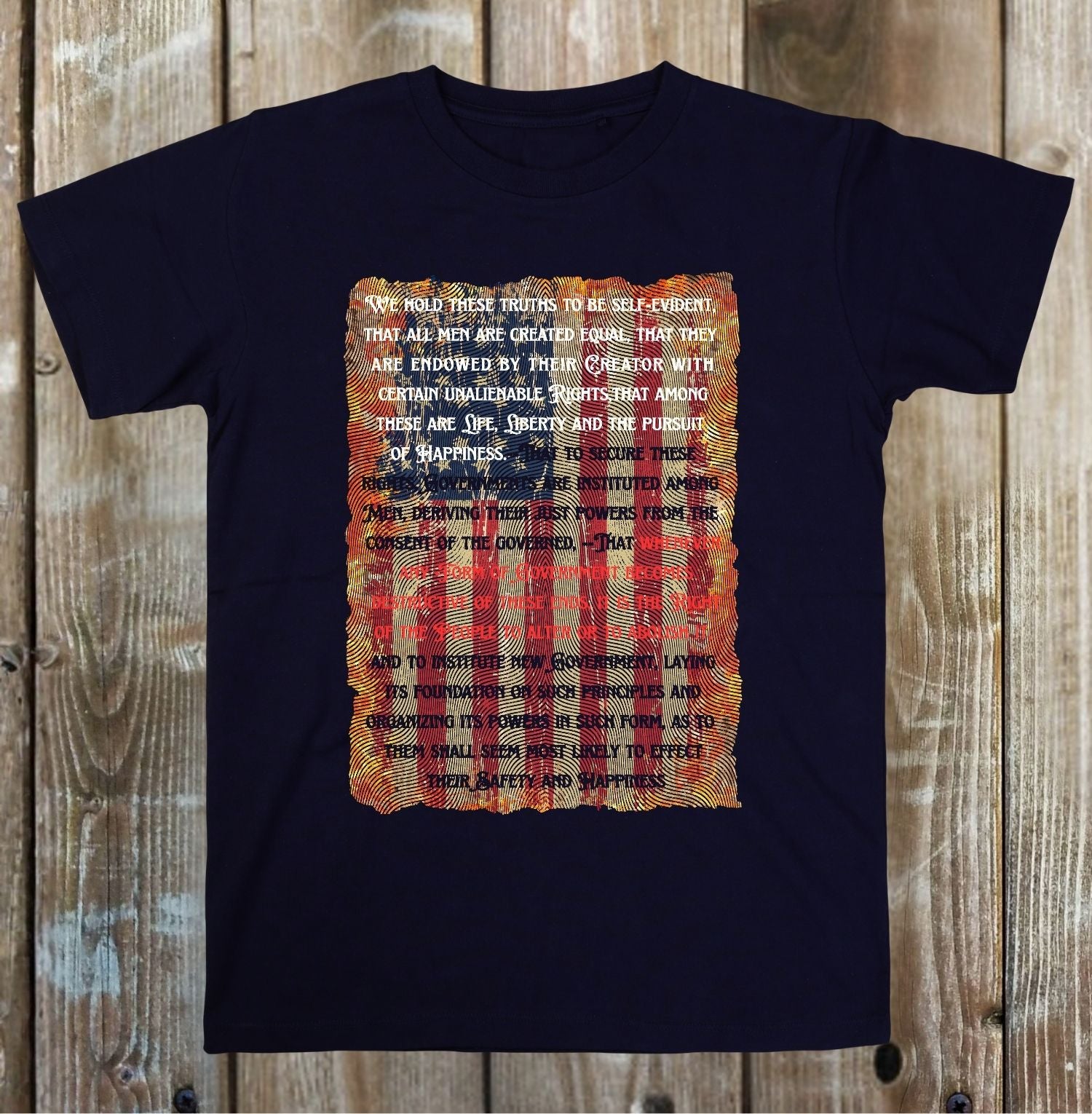 Black t-shirt with a printed design on a wooden surface