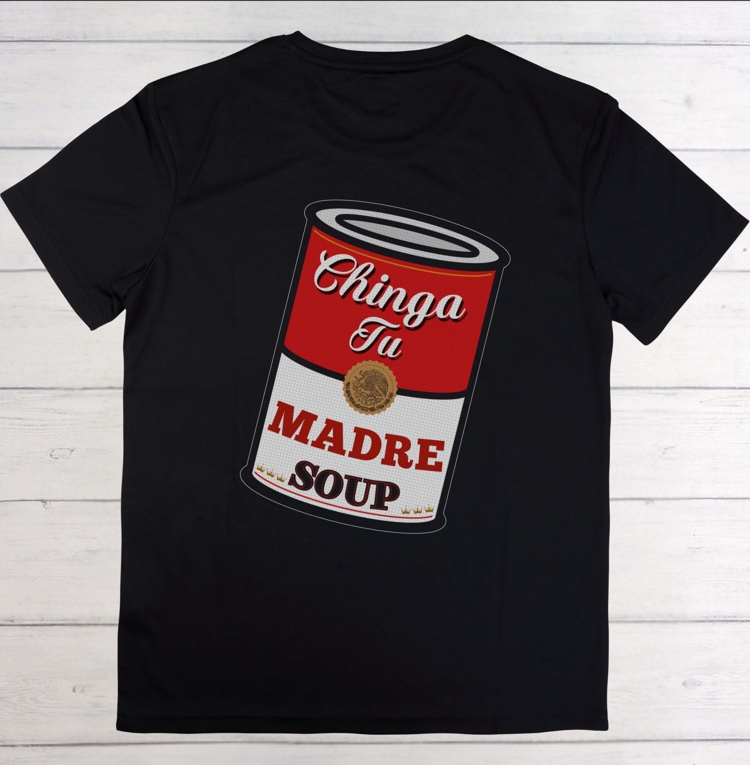 Black t-shirt with a graphic of a red and white soup can on a wooden surface