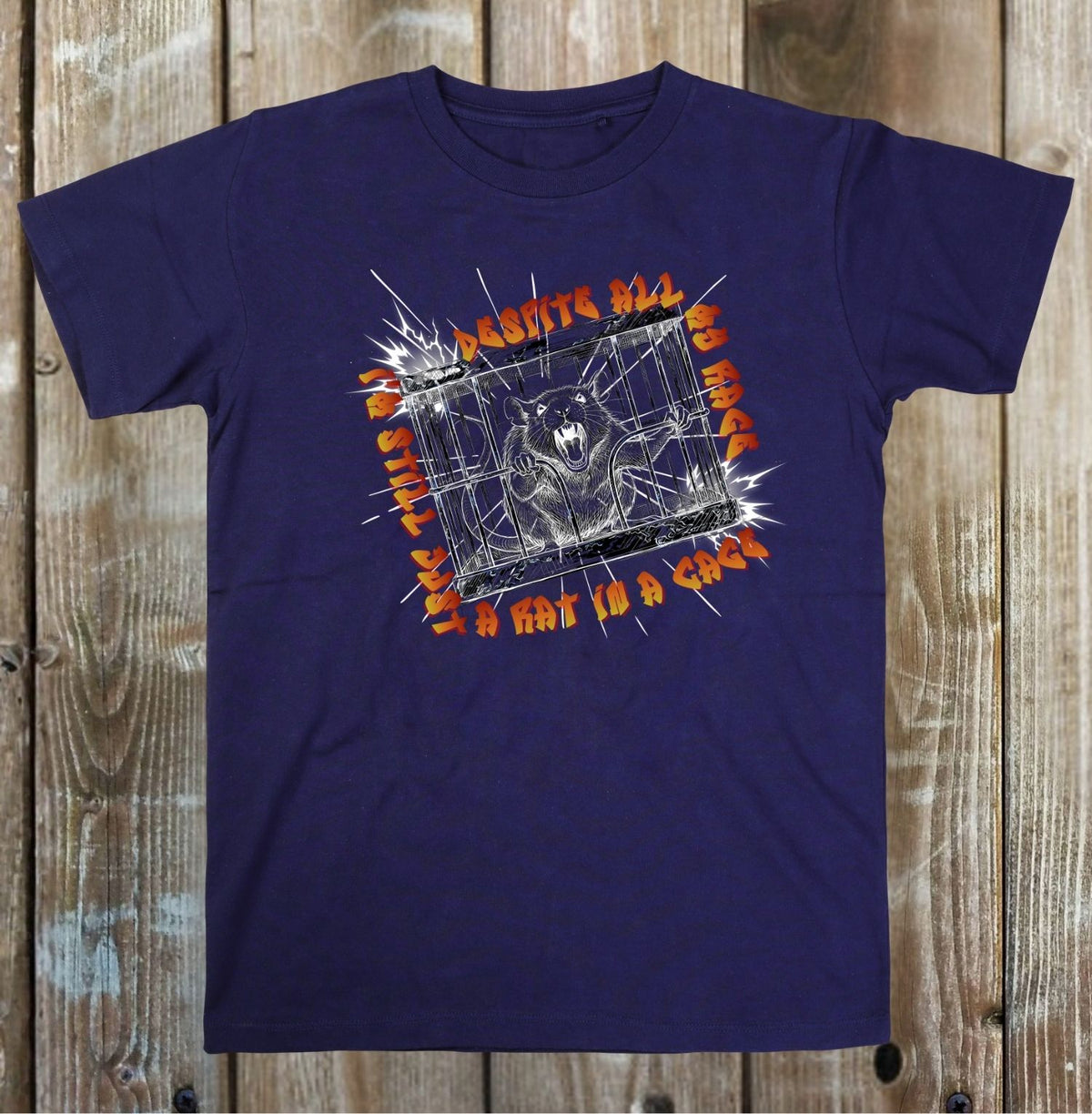 A navy blue short-sleeve graphic t-shirt laid flat on a rustic wooden plank background. The graphic features a spiderweb design with a spider in the center, orange text reading 'I AM NOT A COW', and white text reading 'PERHAPS ALL'.