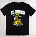 A black short-sleeve t-shirt laid flat on a white wood plank background, featuring a colorful graphic of a cartoon donkey wearing a sombrero and blue bandana beneath the text 'EL BURRO'.