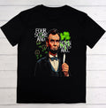 Black t-shirt with a graphic of a historical figure holding a lighter, on a wooden surface.