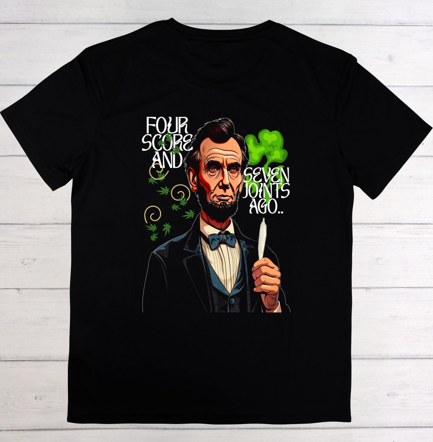 Black t-shirt with a graphic of a historical figure holding a lighter, on a wooden surface.
