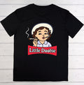A black short-sleeve t-shirt laid flat on a white wood plank background, featuring a cartoon graphic of a woman with brown hair, a white hat, and a red banner that reads 'Little Doobie'.