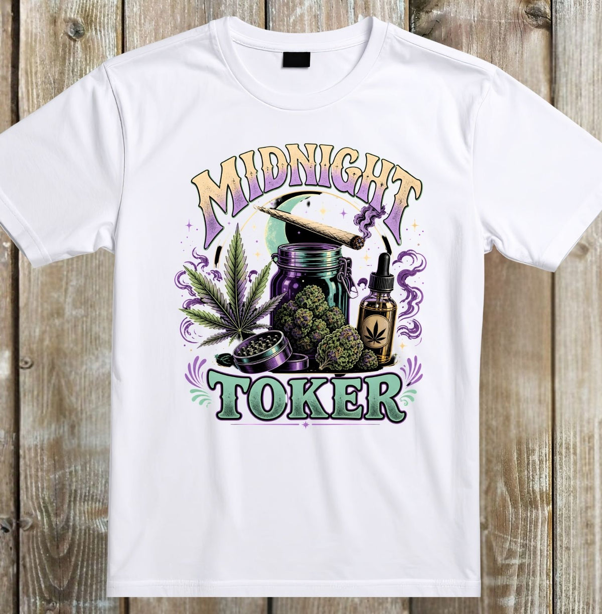 A white short-sleeve crewneck t-shirt with a colorful graphic print on the front, laid flat against a rustic wooden plank background. The graphic features the words 'MIDNIGHT TOKER' in stylized purple and green lettering, surrounding an illustration of a joint, a bong, a cannabis leaf, and a dropper bottle.