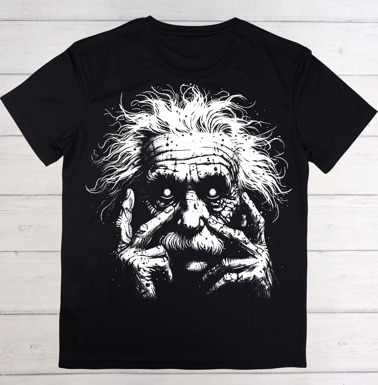 Black t-shirt with a graphic design of a face with long hair and a bandana on a wooden background