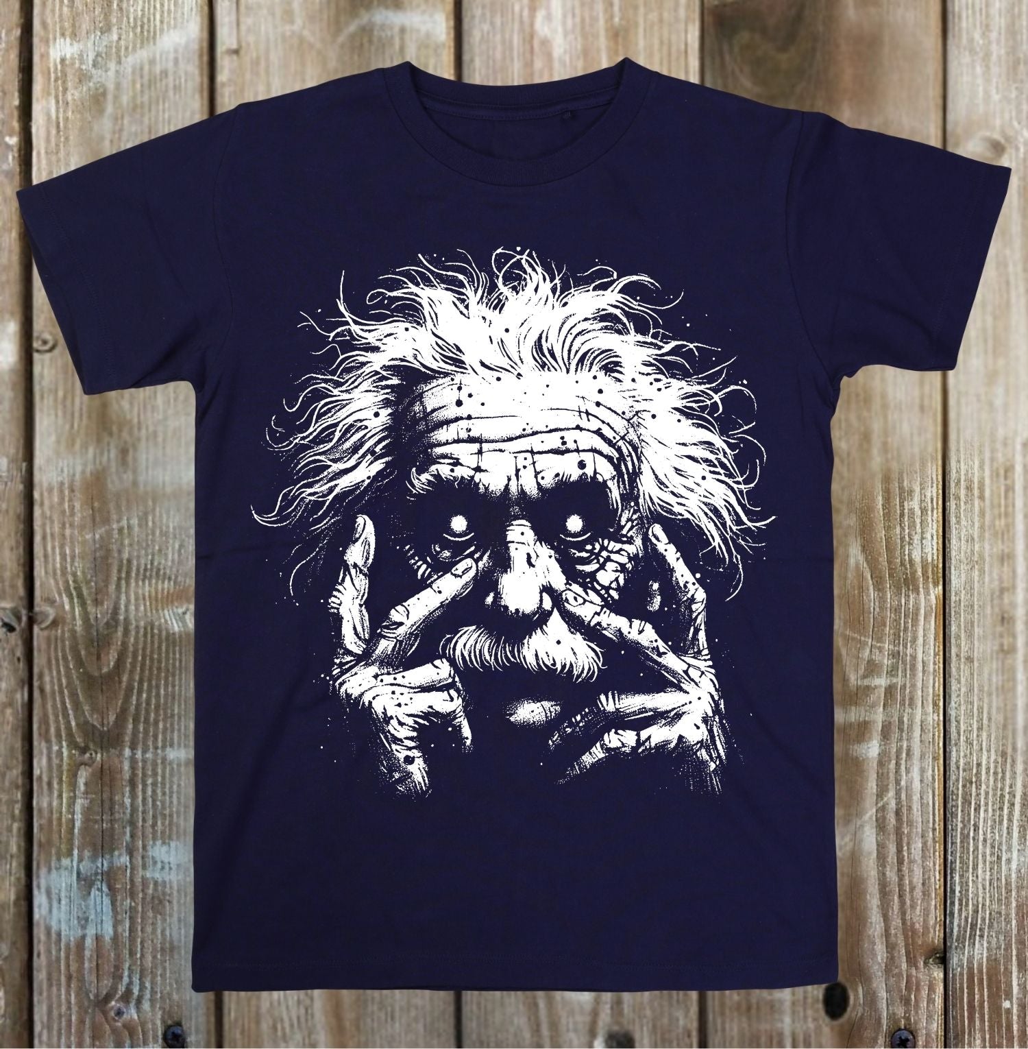 Navy blue t-shirt with a graphic design of a face on a wooden surface