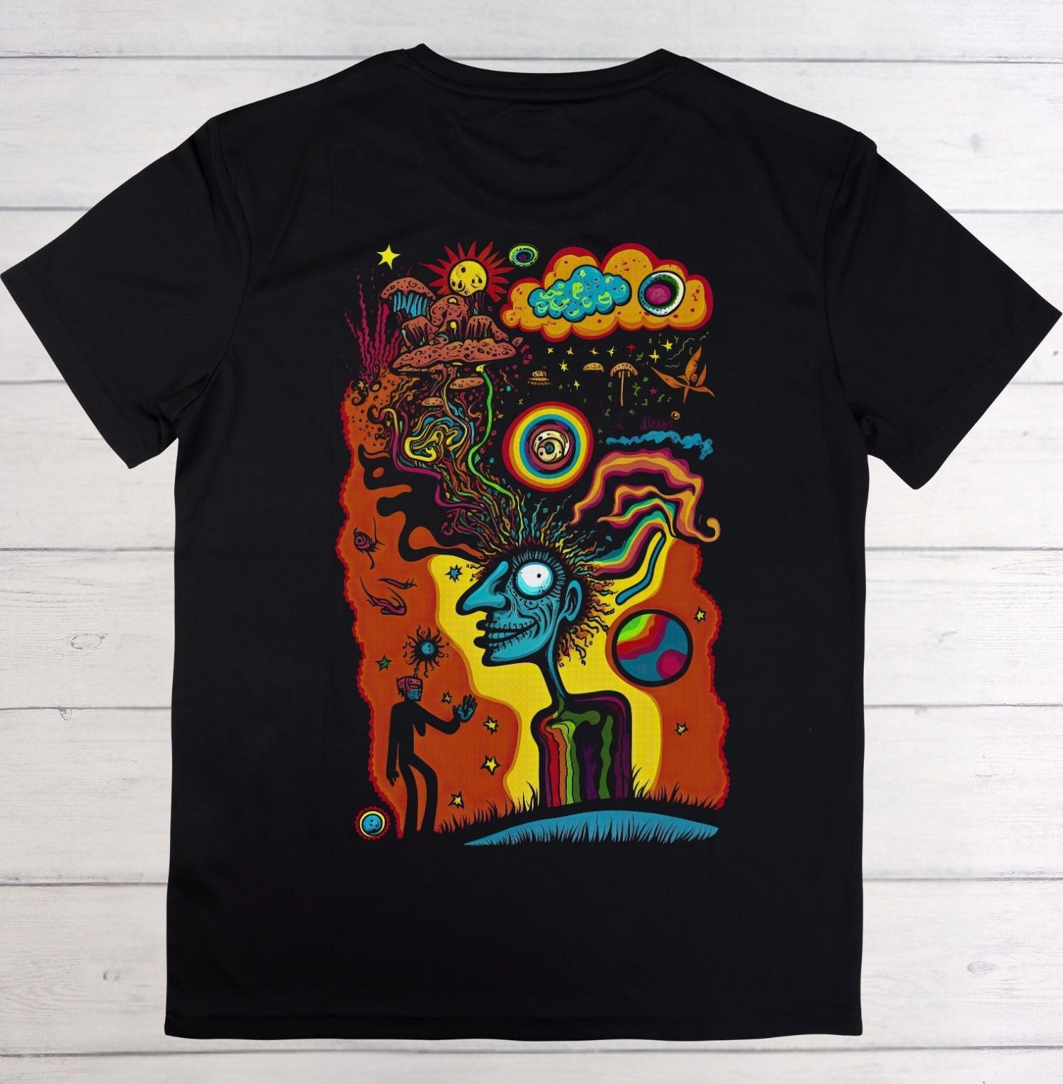 Black t-shirt with a colorful abstract design on a wooden surface