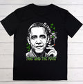 A black short-sleeve t-shirt with a graphic print of Barack Obama smoking a joint, featuring green cannabis leaves and the text 'OF COURSE I'M HIGH' and 'THAT WAS THE POINT'.