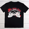 A black short-sleeve t-shirt laid flat on a white wood plank background, featuring a graphic print of two skeletal hands holding an open eye with red splatter details and the text 'OPEN YOUR EYES' in red gothic lettering.