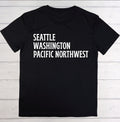 Black t-shirt with 'Seattle Washington Pacific Northwest' text on a wooden surface