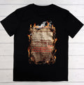 Black t-shirt with a design of a burning document on a wooden surface