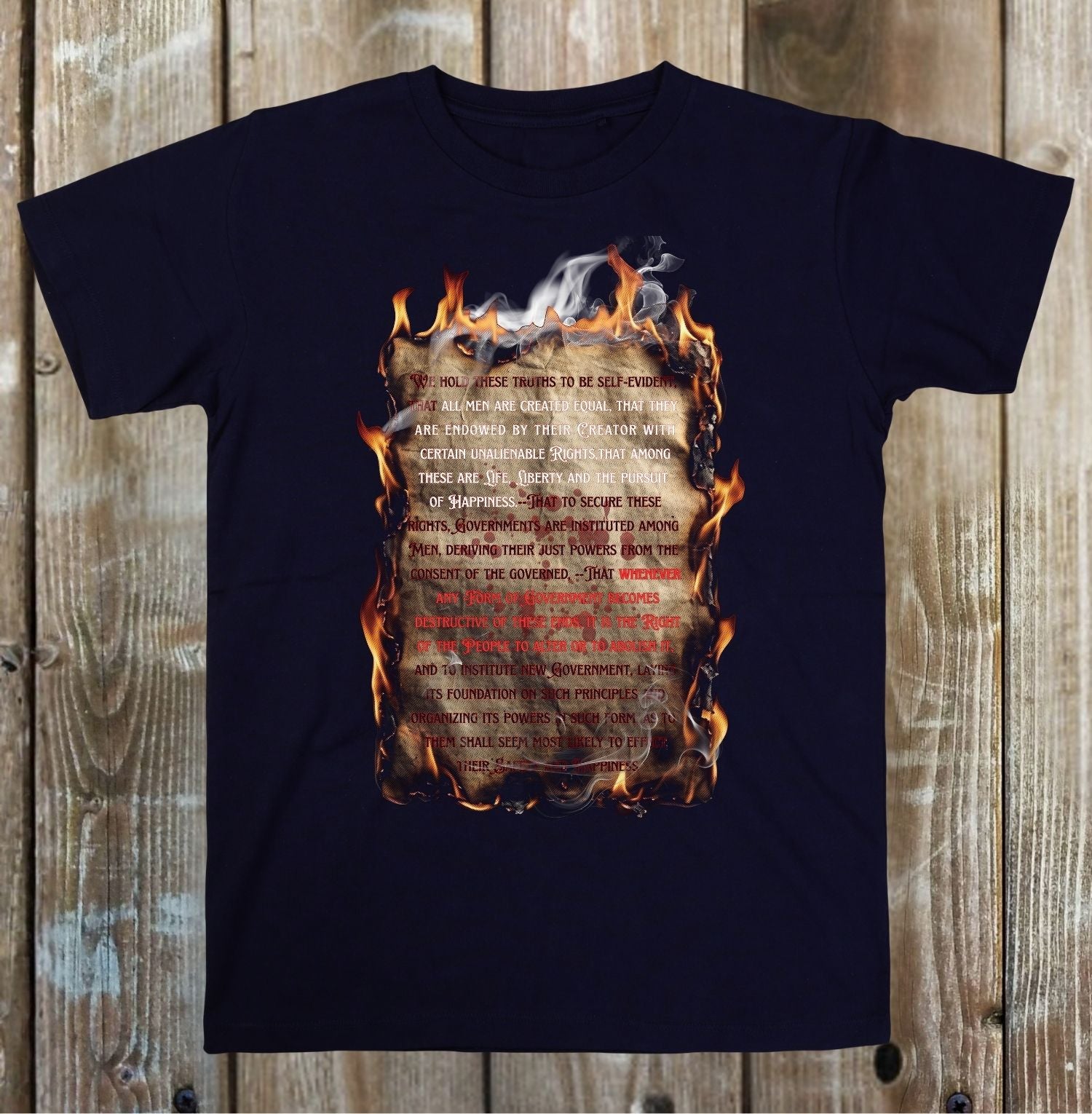 Black t-shirt with a printed design on a wooden background
