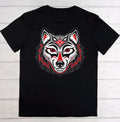 A black short-sleeve crewneck t-shirt featuring a stylized red, white, and black wolf head graphic on the chest, laid flat on a white wood plank background.