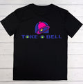 A black short-sleeve t-shirt laid flat on a white wood plank background, featuring a colorful graphic of a bell with a green eye and the text 'TOKE BELL' in blue with green leaf icons.