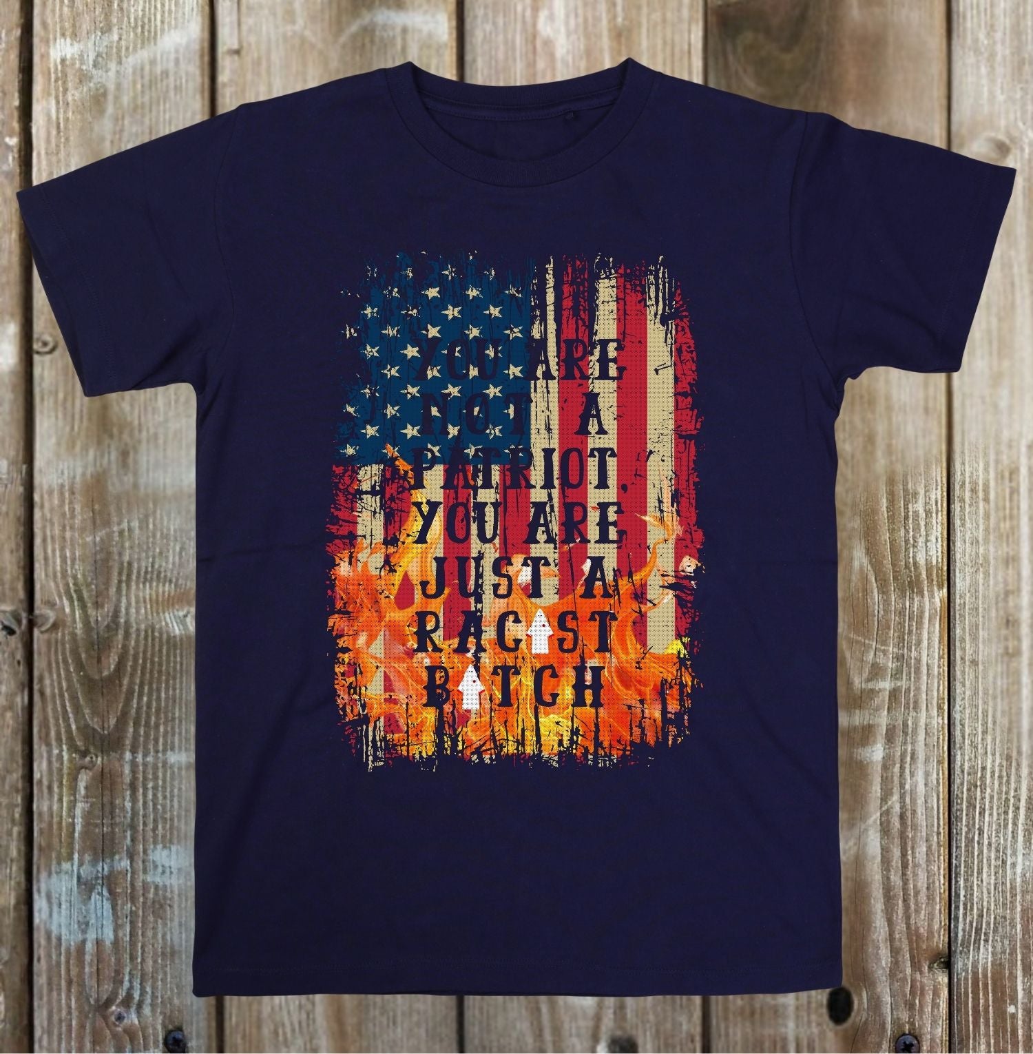 Navy blue t-shirt with American flag graphic and text on a wooden background